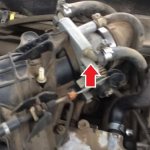 The arrow indicates the throttle assembly installed on the car